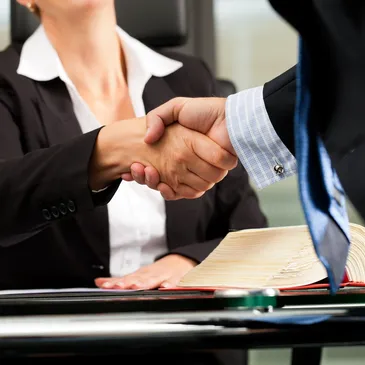 Handshake across desk